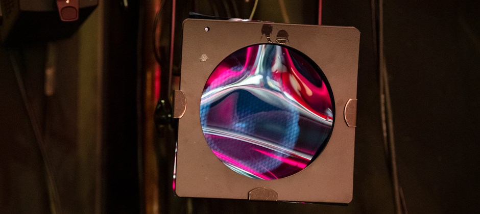 Släkt strålkastare i närbild. Filmduken glittrar i blått och rosa. Släkt strålkastare i närbild. Filmduken glittrar i blått och rosa.